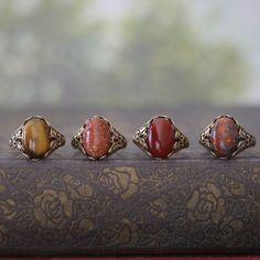 14 x 10mm cabochon on an antiqued sterling silver plated or brass adjustable ring.  Easy to adjust to any size. Choose from Tigereye, Goldstone, Carnelian or Leopardskin Jasper. Jasper Aesthetic, Leopardskin Jasper, Cameo Bracelet, Orange Ring, Jasper Jewelry, Jasper Ring, Group Gifts, Cameo Ring, Snowflake Obsidian