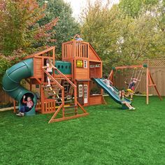 a children's play set with a slide and climbing frame in the back yard