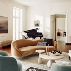 a living room filled with furniture and a piano