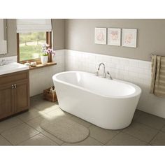 a large white bath tub sitting inside of a bathroom