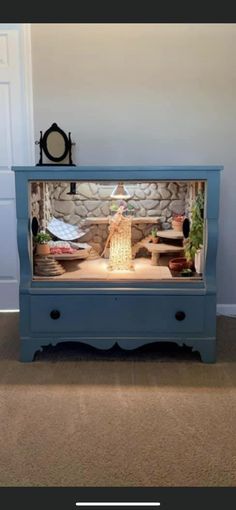 a blue dresser with an aquarium in it