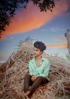 a woman sitting on top of a pile of hay