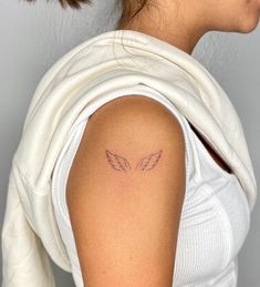 a woman with a small tattoo on her arm