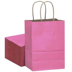 pink paper bags stacked on top of each other