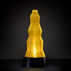 a yellow lamp sitting on top of a black table