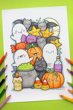 a halloween coloring page with lots of cats and pumpkins in the background, surrounded by colored pencils