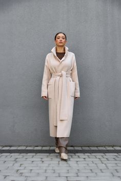 Women's Belted Cardigan, Wool Long Coat with Pockets, Knitted Coat Straight Silhouette, Knit Woolen Cardigan, Beige, Brown Knitted coat made of warm semi-woolen yarn. Straight, comfortable silhouette, made in a stable weave. Practical patch pockets, double collar that holds its shape well. The set includes a knitted belt to match. Hooks are included with each product. Composition     40% - WOOL     25% - VISCOSE     20% - ACRYLIC-SOFT     15% - POLYAMIDE The cardigan is made in two universul siz Long Sweater Coat For Winter Daywear, Winter Long Sweater Coat For Daywear, Cream Sweater Coat For Winter Workwear, Beige Wool Knitted Outerwear, Winter Workwear Cream Cardigan, Cream Cardigan For Winter Workwear, Winter Cream Cardigan For Work, Cozy Beige Outerwear For Daywear, Beige Shawl Collar Sweater Coat For Fall