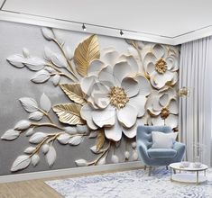 a living room with a couch, chair and large flower wall mural on the wall