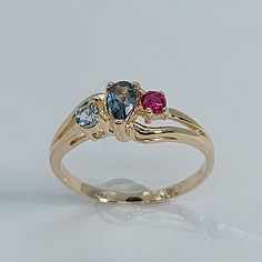 This stunning  ring has been carefully crafted in warm 14K Yellow gold, authentic Ruby , Aquamarine and Blue Topaz. Great for any occasion! Buy it for your-self or for someone you love! This stunning ring will make a beautiful special occasion/birthday gift. All of my jewelry is handmade from scratch and of high quality. Once ring has been mailed a tracking shipping number will be provided to you. Ring Measurements and Materials: Ring is size 6  but can be resized at no extra cost and will be sh Three Stone Blue Topaz Sapphire Promise Ring, Multi-stone Blue Topaz Rings For Promise, Blue Topaz Multi-stone Promise Ring, Hallmarked Blue Topaz Birthstone Promise Ring, Multi-stone Blue Topaz Ring In Yellow Gold, Yellow Gold Three Stone Topaz Ring In 14k Gold, Blue Topaz Multi-stone Rings For Anniversary, Anniversary Multi-stone Blue Topaz Rings, Multi-stone Blue Topaz Birthstone Ring