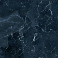 a black marble textured surface with white streaks on the top and bottom, as well as dark blue veining