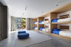 a room with bunk beds and blue pillows