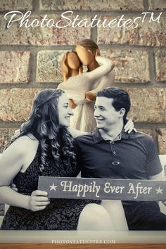 a man and woman sitting on a bench next to each other holding a sign that says happily ever after