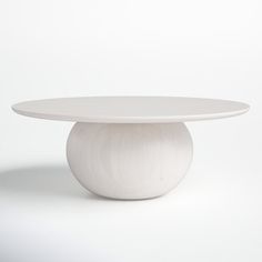 a white table sitting on top of a white floor