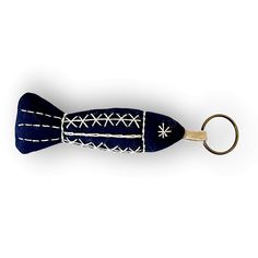 a blue and white fish shaped key chain