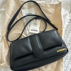 Like New. Not Used As A Daily Bag, Only Used A Few Times. Has Both A Shoulder And Crossbody Strap. No Scratches Or Discoloration. Edges Are In Perfect Condition. Only Slight Crease On Flap Where You Open Bag. In Great Condition Overall. Clean On Inside. Selling Bc Initially Bought It As A Daily Bag, But Found It Too Small For My Needs & Did Not Use Much. Beautiful Soft Black Leather With Gold Hardware. Tags Not Attached, But Have Dust Bag And Tag For It, Along With 2 Bag Straps. Have Original Receipt If Needed For Proof Of Purchase. Bag Now Retails For $1235, Purchased Last Year For $1145 Plus 8.5% Tax. Bags Jacquemus, Jacquemus Bags, Jacquemus Bag, My Needs, Daily Bag, 2025 Vision, Soft Black, Black Outfit, Bag Straps