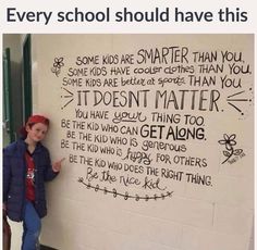 a girl standing in front of a white wall with writing on it that says, this should be posted in every school