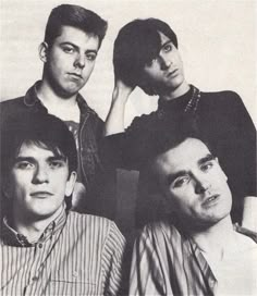 four young men are posing for a black and white photo