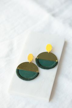 I have designed the pieces in this collection to be easy to wear with anything. I wanted to focus on the shapes and composition of the pieces themselves as opposed to the stitches on them. These earrings are made from Forest Green cotton which has been interfaced to provide structure. I have bound the edges in a band with matching embroidery thread in Forest Green. This is joined to a brass semi-circle which is hung from a brass circle with a gold plated earpost. All findings are Gold Vermeil an Hammered Gold, Green Cotton, Round Earrings, Forest Green, Druzy Ring, Embroidery Thread, Gold Vermeil, Gold Plate, Dangle Drop Earrings