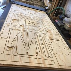 a wooden table that has a maze on it and some wires attached to the top