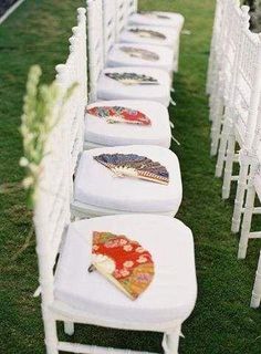 rows of white chairs with different designs on them