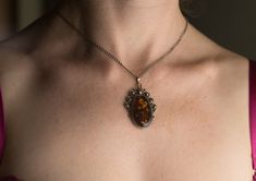 Amazing pendant with heated amber and chain 42 cm! Very elegant and luxurious piece of jewelry. All our items have been handmade with love and care more than 35 years ago by our family member - uncle Alfreds Holsts using the amber which Alfred acquired in his lifetime from the coast of the Baltic Sea (from 40,000,000 to 60,000,000 years old), which is the best-known and called succinite amber for containing a substantial amount of succinic acid. As the amber is as nature has made it - unique, it Elegant Handmade Tortoiseshell Jewelry, Baltic Amber Round Pendant Necklace, Elegant Handmade Baltic Amber Necklaces, Elegant Handmade Baltic Amber Necklace, Handmade Baltic Amber Gold Necklaces, Amber Cabochon Round Pendant Necklace, Elegant Baltic Amber Round Pendant Jewelry, Antique Brown Pendant Jewelry, Handmade Tortoiseshell Jewelry Gift