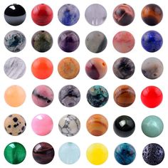 an assortment of different colored marbles on a white background