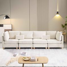 a living room with a white couch and coffee table