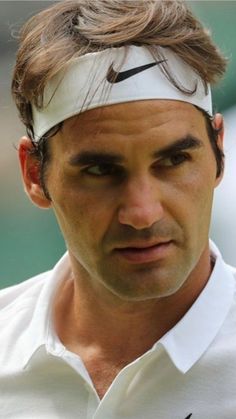 a close up of a tennis player wearing a headband