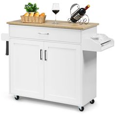 a white kitchen island cart with wine and bread on the top, sitting next to a glass of red wine