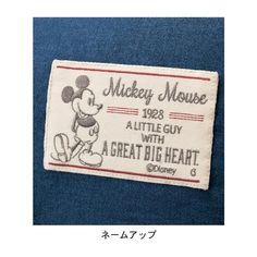 the mickey mouse badge is shown on a blue shirt