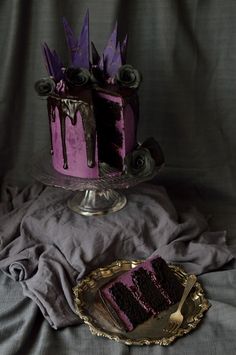 there is a purple cake with icing on the top and one slice missing from it