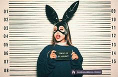 a woman wearing a bunny mask and holding a mug in front of a jail cell