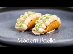 two pieces of food with green and white icing on them sitting on a plate