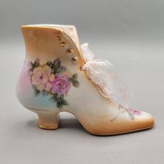 Porcelain Victorian boot with roses design all around. Beautiful pastel colors. R S Prussia red mark is a reproduction mark. Features: * Victorian * Floral Measurements: Length 5 in / 13 cm Width 2 in / 5 cm Height 4 in / 10 cm Condition: Pre-Owned Good Inside is a bit dirty/dusty.  F091024 Victorian Boots, Roses Design, Red Marks, Historical Dresses, Collectible Figurines, Pastel Colors, Floral Lace, Shoe Boots, Figurines