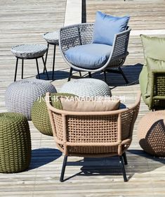 several chairs and ottomans on a wooden deck