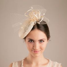 The millinery wedding hat in natural colour of sinamay is trimmed with a veiling bow for a touch of wedding tradition. With a voluminous bun or an elegant updo sitting glamorously under a this hat, your style will be striking and sophisticated. The bridal hat makes a civil ceremony feel like the special and unique moment.  Pictured in natural sinamay colour.  If you prefer this hat in more understated version, choose the colour matching your hair colour.  Available in various colour, please, see Elegant Cream Party Veil, Cream Mini Hat For Summer Ceremony, Cream Mini Hats For Summer Ceremonies, Cream Mini Hat For Summer Ceremonies, Summer Ceremony Cream Mini Hats, Adjustable Cloche Fascinator For Wedding, Elegant Cream Costume Hats And Headpieces For Ceremony, Elegant Beige Straw Hat With Structured Crown, Elegant Wedding Veil For Kentucky Derby