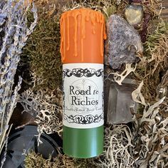 an orange and green tube sitting on top of some grass next to rocks and plants