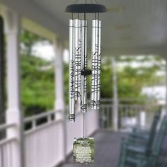 a wind chime hanging from the side of a porch