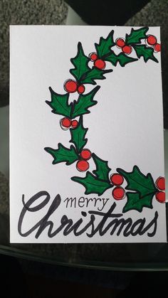 a christmas card with holly and berries on it