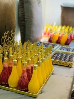 there are many bottles that have different types of drinks in them on the trays