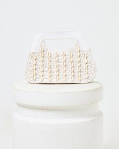 Seashells make everything better! The Miley Bag features a unique cowry shell pattern, magnetic closure and cotton-yarn body. It's also fully lined inside with a perfectly-sized pocket. cotton yarn clutch cowry shell pattern magnetic closing fully lined pocket inside Material: 100% Paper Style # LSMIL24 Everyday White Straw Pouch Bag, White Crochet Bag With Removable Pouch For Summer, White Top Handle Crochet Bag For Everyday Use, White Crochet Bag With Top Handle For Everyday, White Straw Bag With Removable Pouch, White Crochet Bag With Removable Pouch For Vacation, White Rectangular Clutch For Vacation, White Clutch Shoulder Bag For Vacation, White Crochet Handheld Bag With Braided Handles