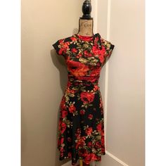 Red Rose Floral Print Dress In New Condition. *Last Photo Is A Stock Photo To Show Style Only. Known For Comfort Without Compromising Style, Bridget Boasts A Side Tie On The Neckline, Short Sleeves And Figure-Flattering Shirring Detail On The Waist. The Fabric Is Smooth And Stretchy, So You Can Rock Your Favorite Retro Look From Work To Play And Beyond! Doll Up With A Cardigan, Bolero, Cropped Jacket, Or Shrug To Create New Looks That Make This Style A Staple With Us Dames. Sorry, No Trades Red Stretch Floral Print Dress, Red Fitted Floral Dress, Fitted Red Floral Dress, Elegant Red Fitted Floral Dress, Red Stretch Floral Mini Dress, Stretch Red Mini Dress With Floral Print, Red Stretch Mini Dress With Floral Print, Casual Red Floral Dress For Party, Vintage Red Floral Print Mini Dress