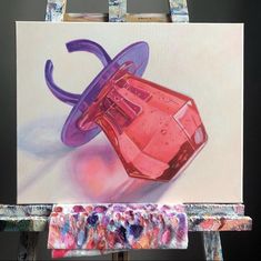 an acrylic painting of a pink cup on a easel