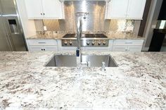 a kitchen with granite counter tops and stainless steel appliances