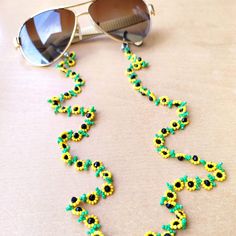 This handmade sunflower jewelry for women is meticulously hand-woven from the finest glass seed beads. Handmade beadwork, eyeglass chain is lightweight and comfortable to carry, so your glasses will not be lost. Lenght 80 cm 31,5 inches The fashion sunflower eyeglass necklace, which is suitable for every outfit and can be used in every season, is the ideal style gift eyeglass chain for you and your loved ones. Guaranteed to receive all compliments. It's not just an eyeglass chain! it is also sunflower necklace, wrap bracelet, cute reading glasses and multi-purpose beaded eyeglasses chain. You can click the link for my other handmade beadwork jewelry and accessories! https://yasminjewelrygifts.etsy.com If there is a color and pattern you want, I will do it for you, you can write a message. Handmade Yellow Beads For Summer, Summer Beaded Glass Necklaces For Gifts, Summer Gift Glass Beaded Necklaces, Summer Glass Beaded Necklaces For Gifts, Summer Glass Beaded Necklaces As Gifts, Handmade Green Glasses Chains With Round Beads, Handmade Gold Beads For Summer, Yellow Glass Beaded Necklace, Handmade Glass Beaded Necklaces For Summer