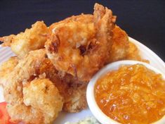 fried food on a plate with dipping sauce