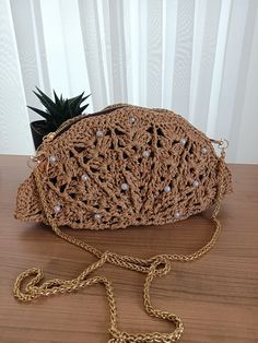 Oyster style raffia shoulder bag, shell likte bag, natural straw tote handbag, eco friendly paper yarn bag Perfect oyster style bag knitted by hand from boho style raffia. It is very trendy and made of handmade natural threads. Its mussel like shape and beige color looks cool with gold-colorde metal strap. Because of the its naive shell shaped you can remove strap and use as a clutch bag. It is very stylish bag and ready for shipping. The size and color of the raffia might be slightly different Elegant Straw Crossbody Bag For Vacation, Chic Beige Braided Crochet Bag, Summer Clutch Shoulder Bag With Braided Handles, Summer Shoulder Clutch With Braided Handles, Beach Crochet Jute Crossbody Bag, Beige Straw Crochet Crossbody Bag, Elegant Crochet Bag With Open Weave For Beach, Elegant Jute Crochet Bag For Spring, Elegant Beach Crossbody Shoulder Bag