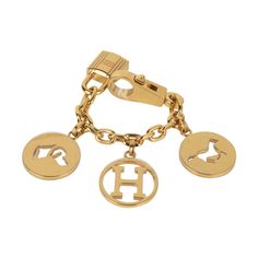 Guaranteed authentic coveted limited edition Hermes Breloque Olga bag charm features 3 signature Gold charms.No longer produced this iconic charm with the horse, dog and H is a marvelous enhancement to any Birkin or Kelly bag.Claw clasp and lock on each end. A collectors piece. Comes with signature Hermes box.Plastic on charms New or Pristine Store Fresh Condition.final saleCONDITION:New or Pristine Store Fresh Condition PLEASE NOTE: This Hermes bag charm payment requires bank wire transfer unle Luxury Yellow Gold Charms With Removable Features, Luxury Yellow Gold Charms With Removable Details, Luxury Yellow Gold Charms With Removable Pieces, Luxury Everyday Jewelry With Logo Charm, Luxury Logo Bag Charm For Gift, Luxury Logo Bag Charm As Gift, Hermes Limited Edition, Hermes Box, Kelly Bag