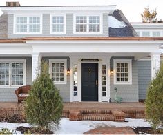 a gray house with white trim and windows