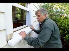 a man that is standing in front of a window